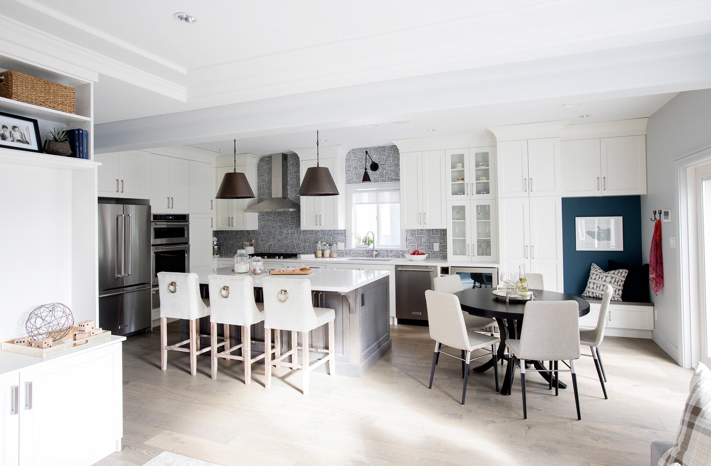 Two-tone kitchen with painted perimeter cabinets and stained island